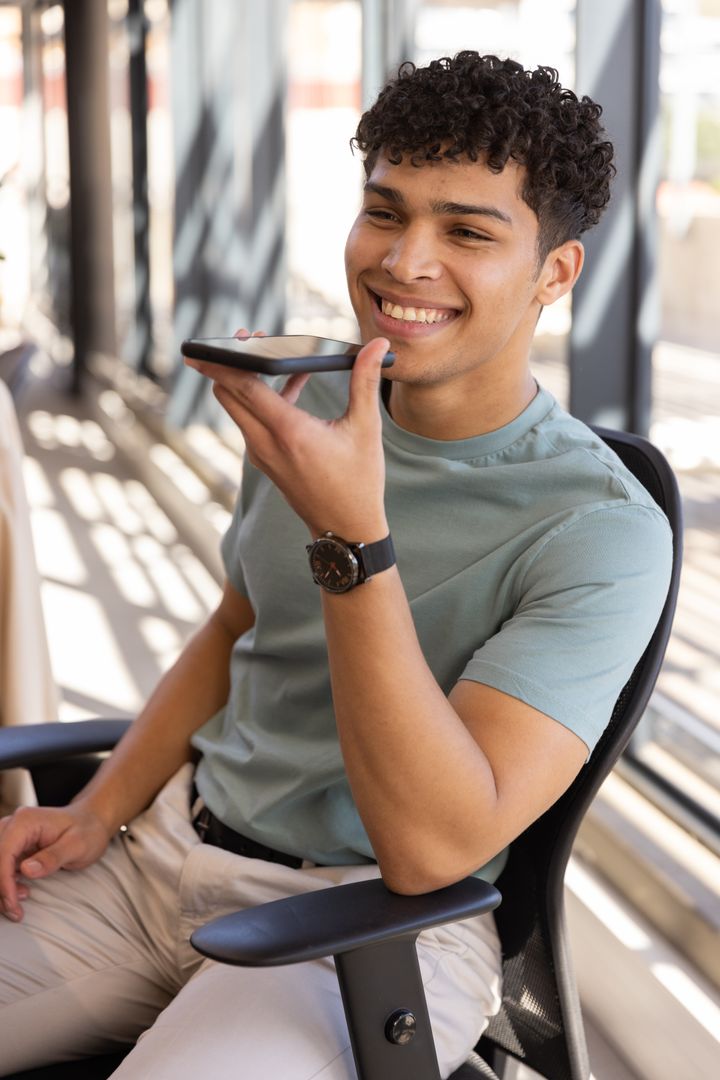Young Professional Engaging with Smartphone in Modern Office