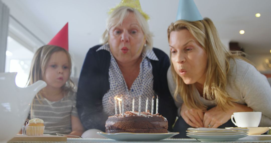 Multigenerational Family Blowing Out Birthday Candles Together - Free Images, Stock Photos and Pictures on Pikwizard.com