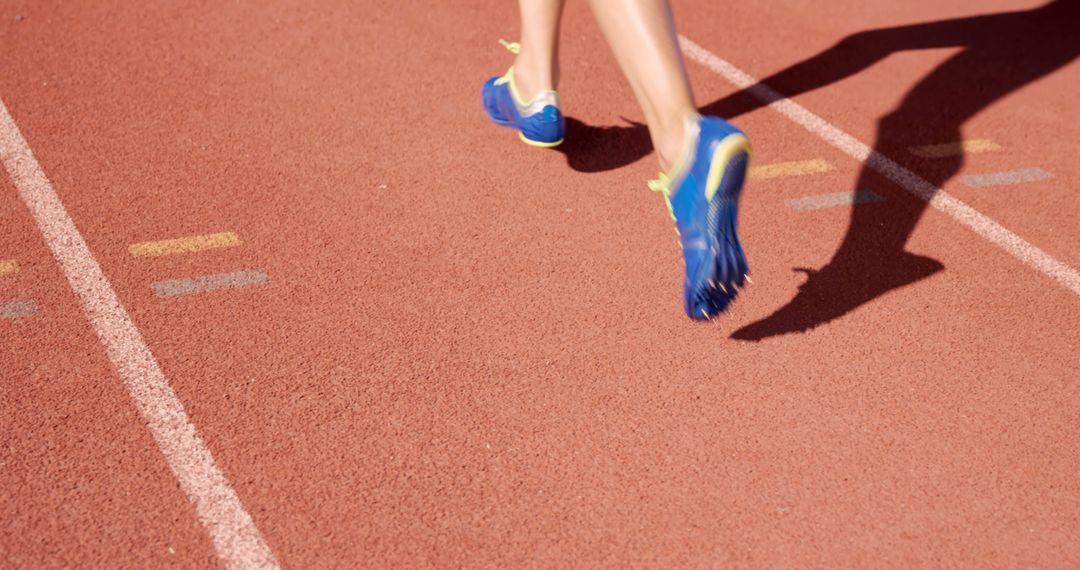 Running Athlete Feet on Track in Blue Shoes - Free Images, Stock Photos and Pictures on Pikwizard.com