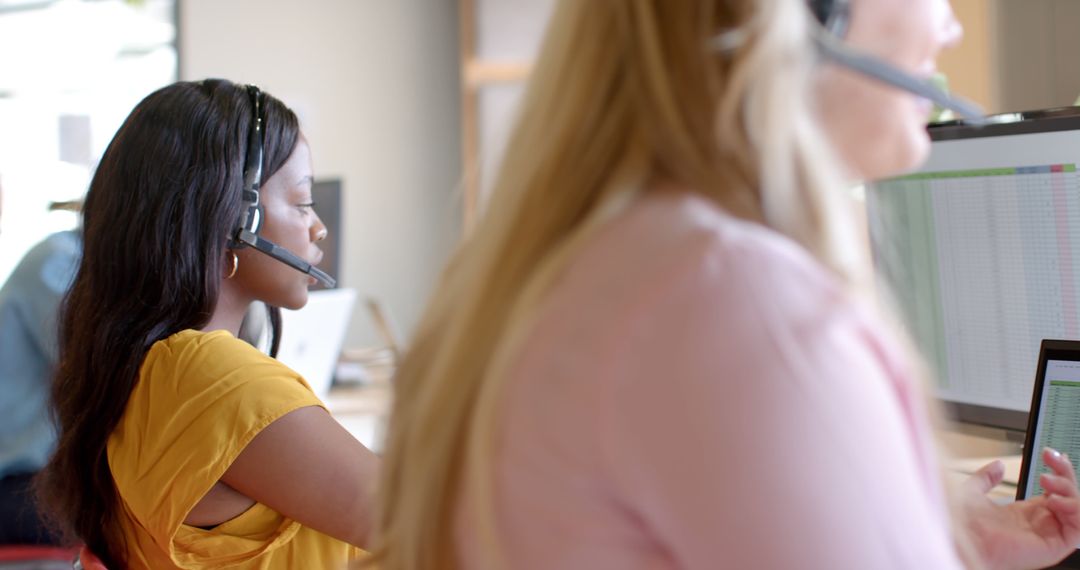Call Center Agents Working on Laptops in Modern Office