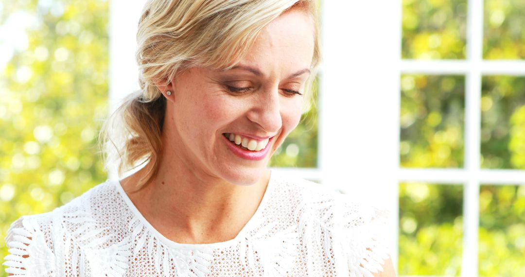 Smiling Blonde Woman in White Lace Blouse - Free Images, Stock Photos and Pictures on Pikwizard.com