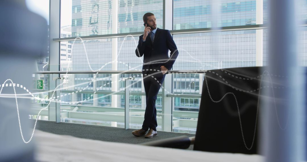 Corporate executive leaning on railing talking on smartphone with waveform overlay in modern atrium