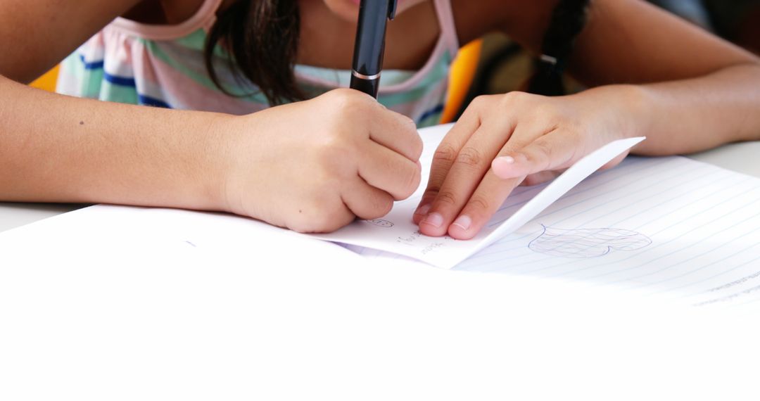 Child Writing on Notebook During Class Activity - Free Images, Stock Photos and Pictures on Pikwizard.com