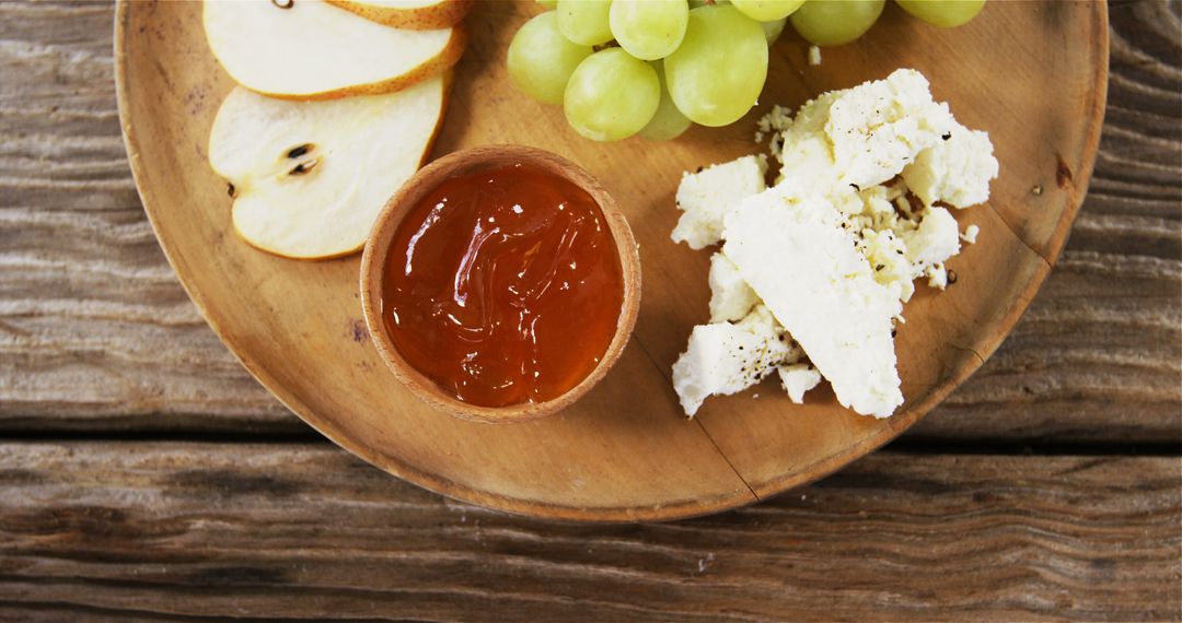 Rustic Cheese Platter with Fresh Grapes, Pear, and Jam on Wooden Table - Free Images, Stock Photos and Pictures on Pikwizard.com