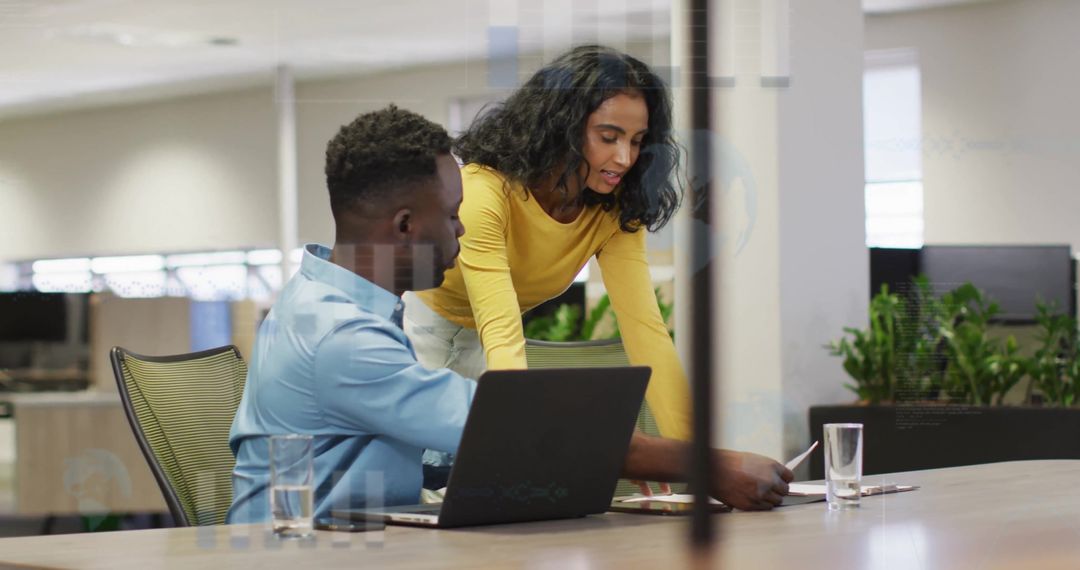 Colleagues Collaborating on Financial Data Analysis in Modern Office