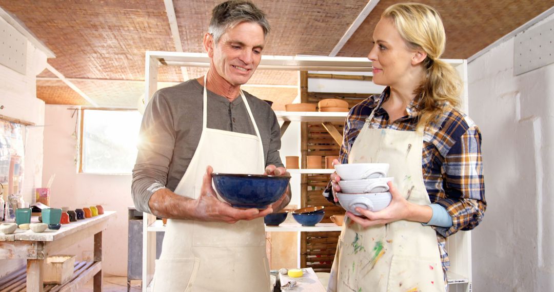 Man and Woman Pottery Artists Holding Ceramic Bowls in Studio - Free Images, Stock Photos and Pictures on Pikwizard.com