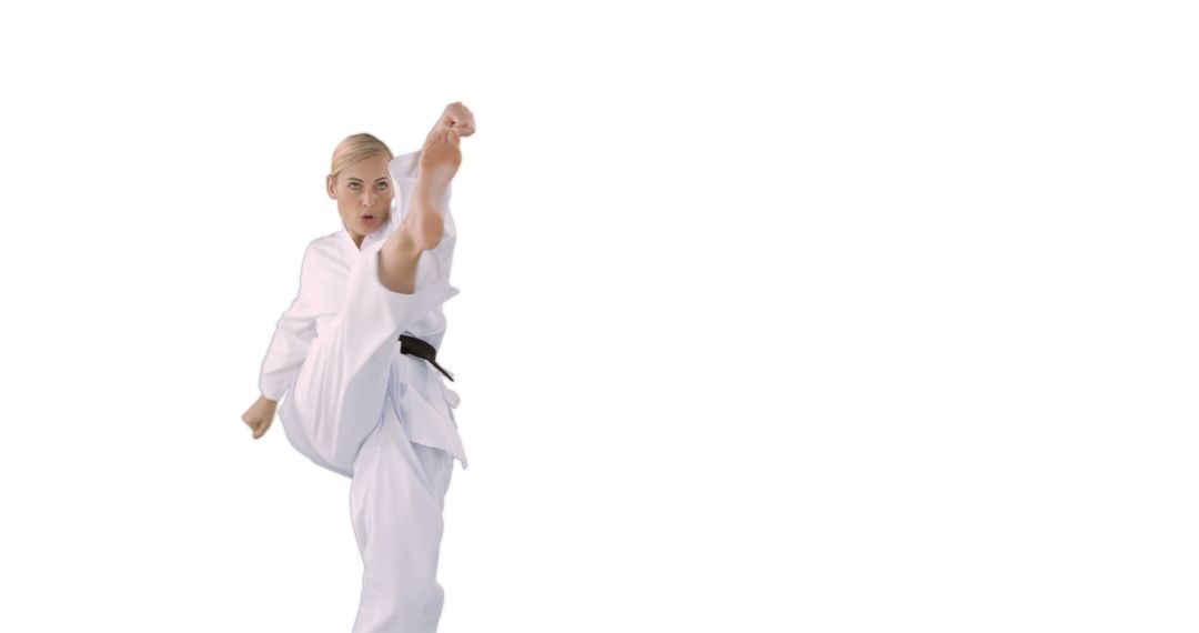 Blonde Woman Practicing High Kick in Karate Uniform - Free Images, Stock Photos and Pictures on Pikwizard.com