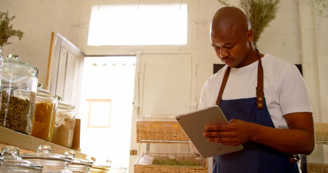 Supermarket Employee Managing Inventory on Tablet