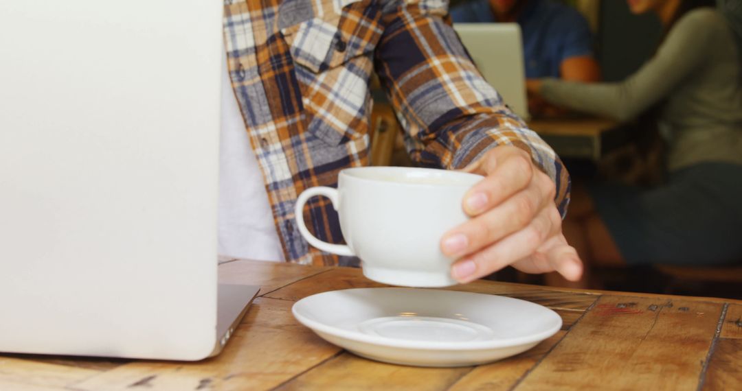 Casual Workday in Cafe Man Reaching for Coffee