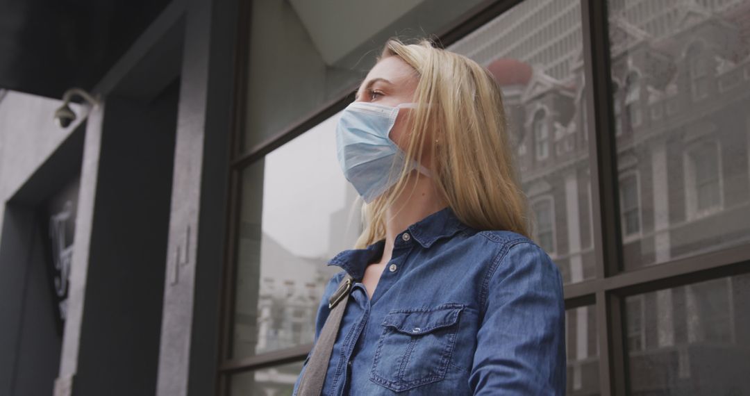 Woman Wearing Face Mask Standing Outdoors in Urban Area - Free Images, Stock Photos and Pictures on Pikwizard.com