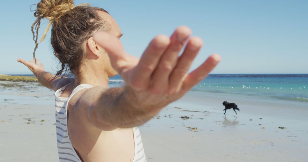 Man with Dreadlocks Relaxing on Beach with Open Arms - Free Images, Stock Photos and Pictures on Pikwizard.com