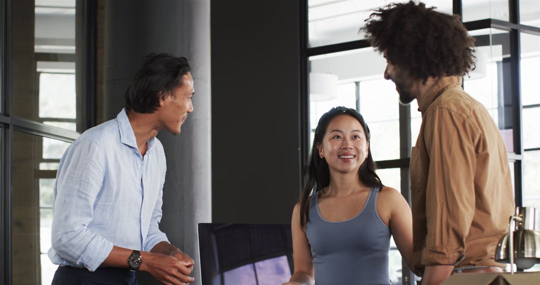 Diverse Colleagues Enjoying Conversation in Modern Office