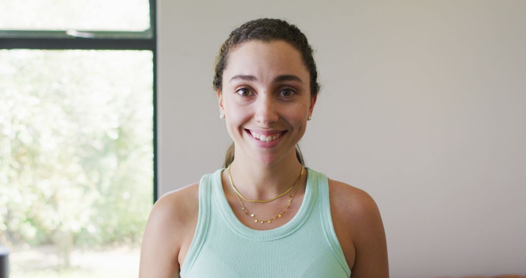 Smiling Woman in Casual Tank Top Relaxing at Home