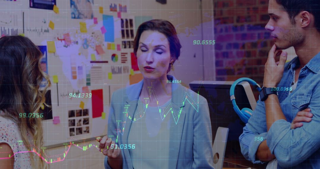 Colleagues Discussing Financial Data with Overlaid Graphs in Modern Office