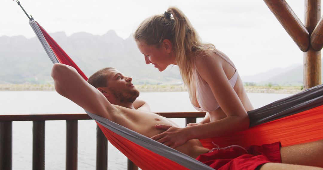 Romantic Couple Relaxing in Hammock by Lake