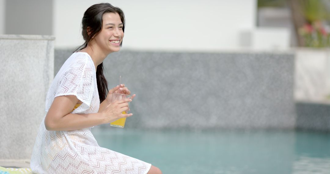Smiling Woman Relaxing by Poolside with Refreshing Drink