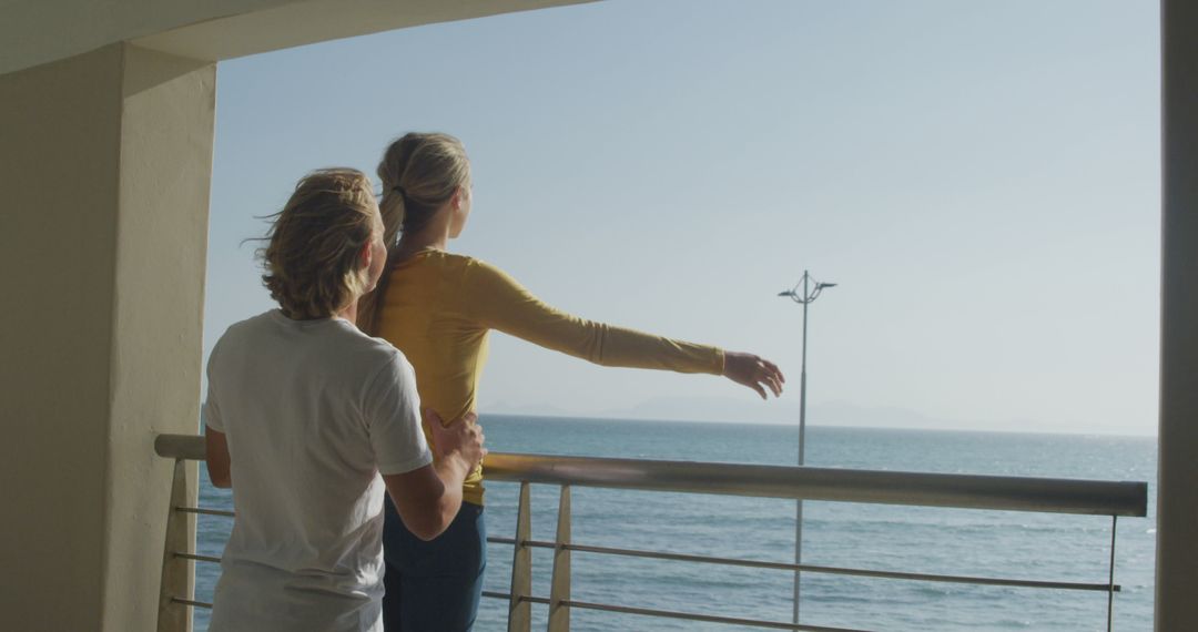 Couple Embracing on Oceanfront Balcony at Sunset - Free Images, Stock Photos and Pictures on Pikwizard.com