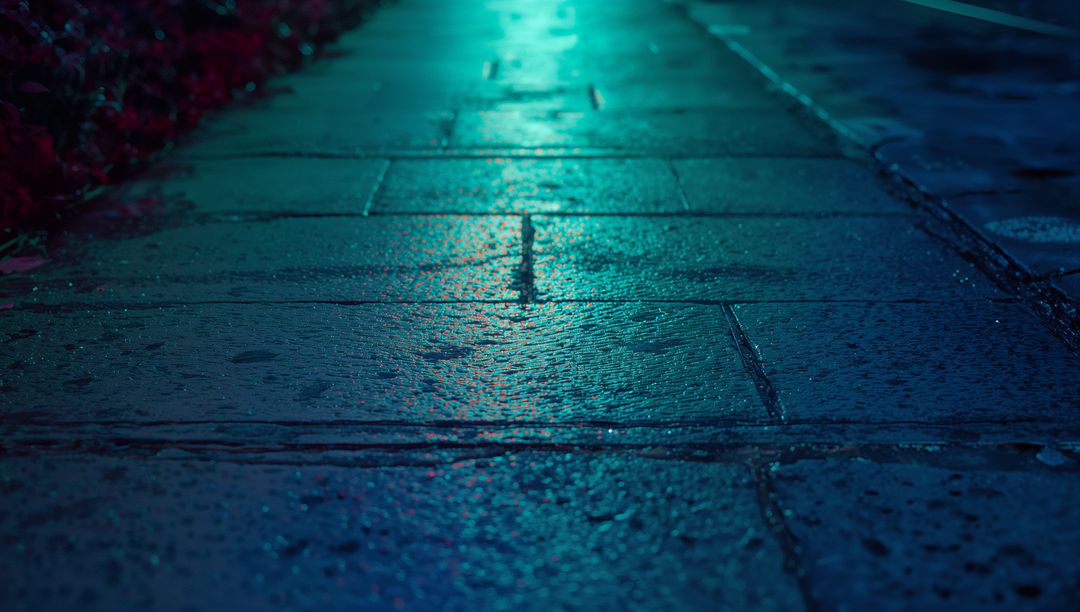 Wet Pavement Reflecting Neon Blue Light at Night