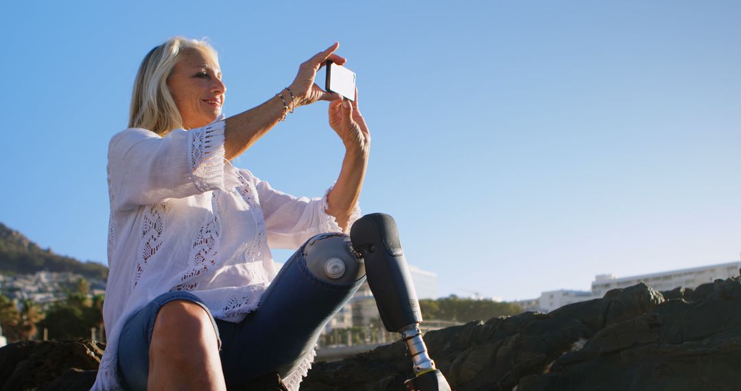 Senior Woman with Prosthetic Leg Taking Selfie Outdoors - Free Images, Stock Photos and Pictures on Pikwizard.com