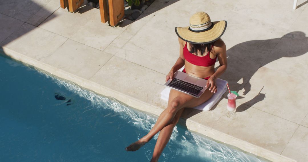 Woman in Red Bikini Using Laptop Sitting by Poolside - Free Images, Stock Photos and Pictures on Pikwizard.com