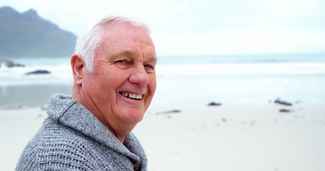 Happy Elderly Man Enjoying Beach on Cloudy Day - Free Images, Stock Photos and Pictures on Pikwizard.com