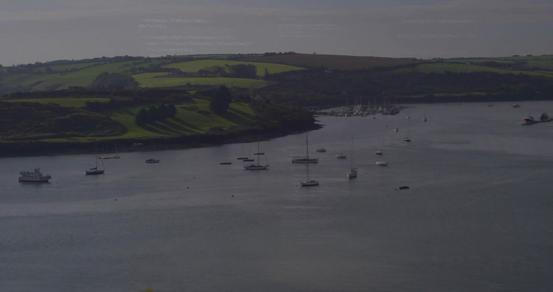 Calm Estuary with Anchored Sailboats and Yachts in Scenic Harbor