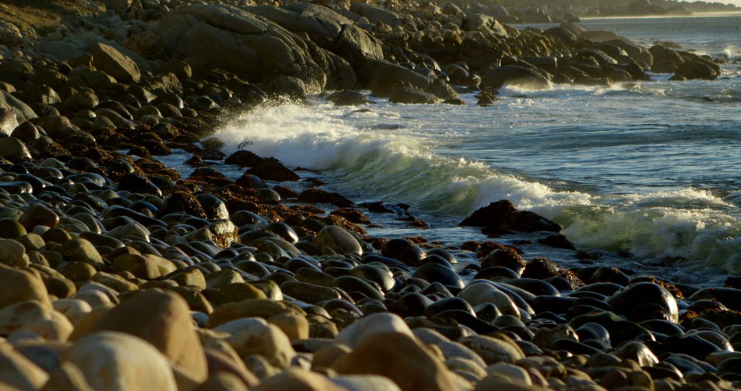 Rocky Shoreline at Sunset with Waves Crashing and Reflections - Free Images, Stock Photos and Pictures on Pikwizard.com