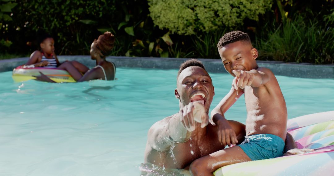Joyful Father and Son Bonding in Pool on Sunny Day