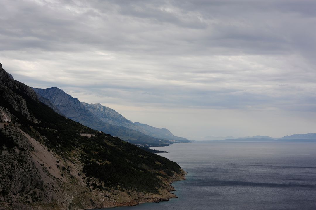 Dramatic Coastal Mountain Landscape Under Cloudy Sky - Free Images, Stock Photos and Pictures on Pikwizard.com