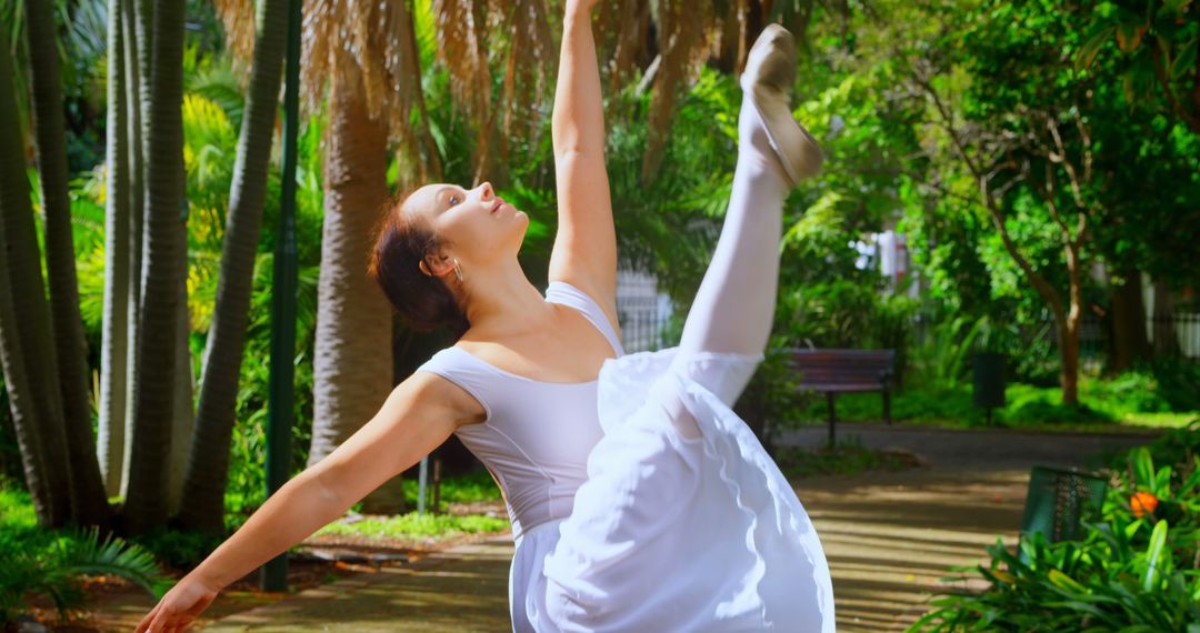 Ballet Dancer Posing Gracefully in Lush Garden Surroundings