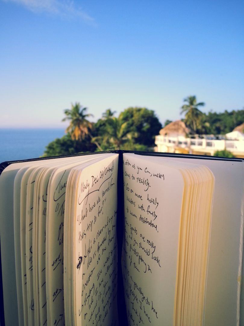 Open Notebook with Handwritten Notes Overlooking Tropical Scenery - Free Images, Stock Photos and Pictures on Pikwizard.com