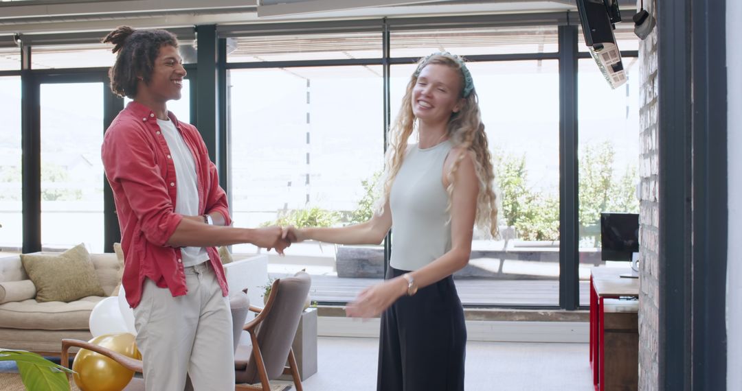 Young Professionals Smiling Handshake Modern Office Collaboration