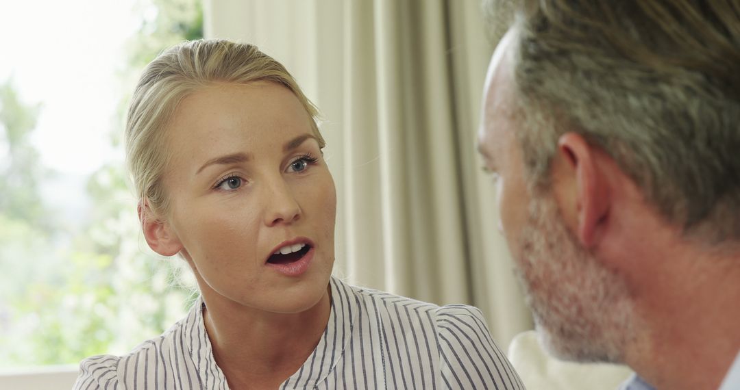 Caucasian Woman in Intense Dialogue with Middle-Aged Man
