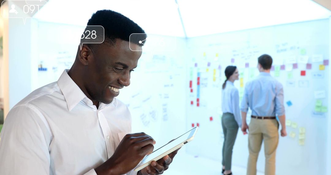 Businessman Using Tablet in Modern Office for Team Brainstorming