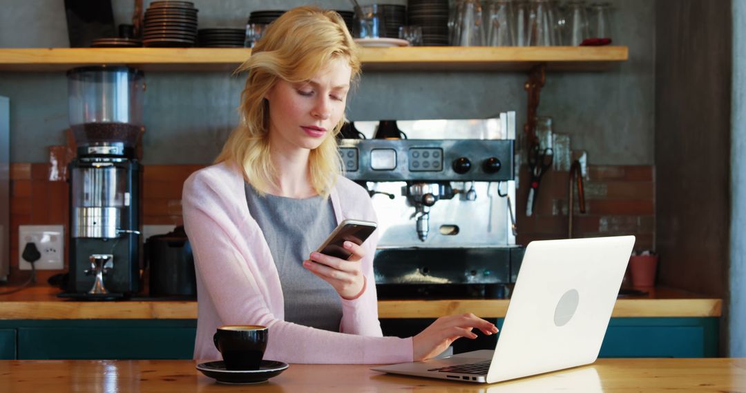 Young Professional Woman Working in Modern Café with Laptop and Smartphone - Free Images, Stock Photos and Pictures on Pikwizard.com