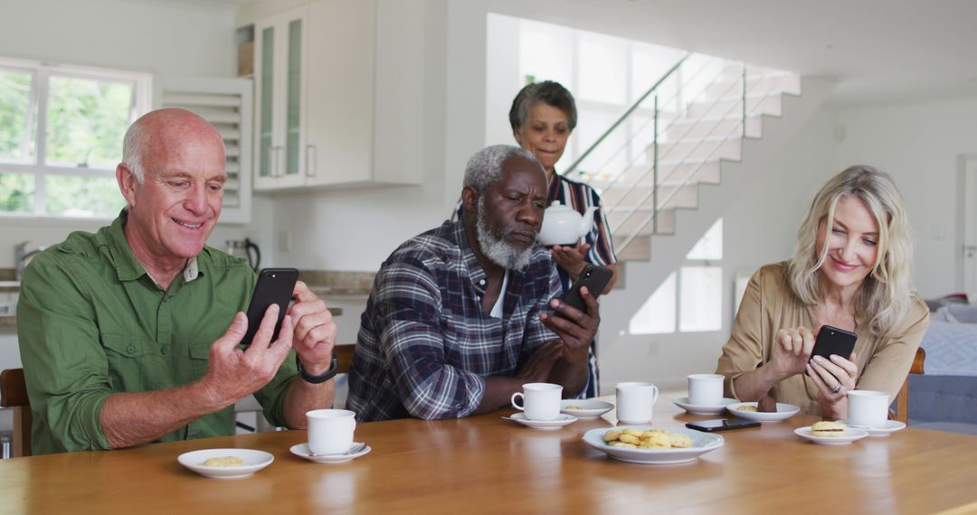 Group of Seniors Enjoying Coffee and Smartphones in Modern Home - Free Images, Stock Photos and Pictures on Pikwizard.com