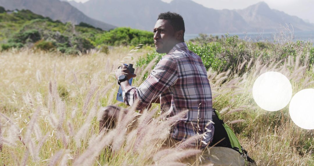 Hiker Exploring Coastal Wilderness with Binoculars