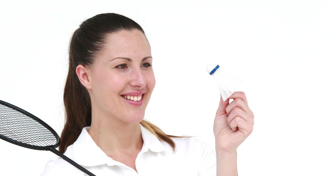 Woman holding badminton racket and shuttlecock, smiling - Free Images, Stock Photos and Pictures on Pikwizard.com