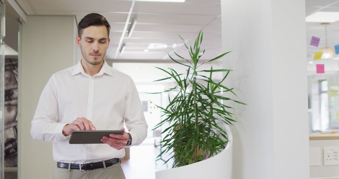 Businessman Using Tablet in Modern Office Environment
