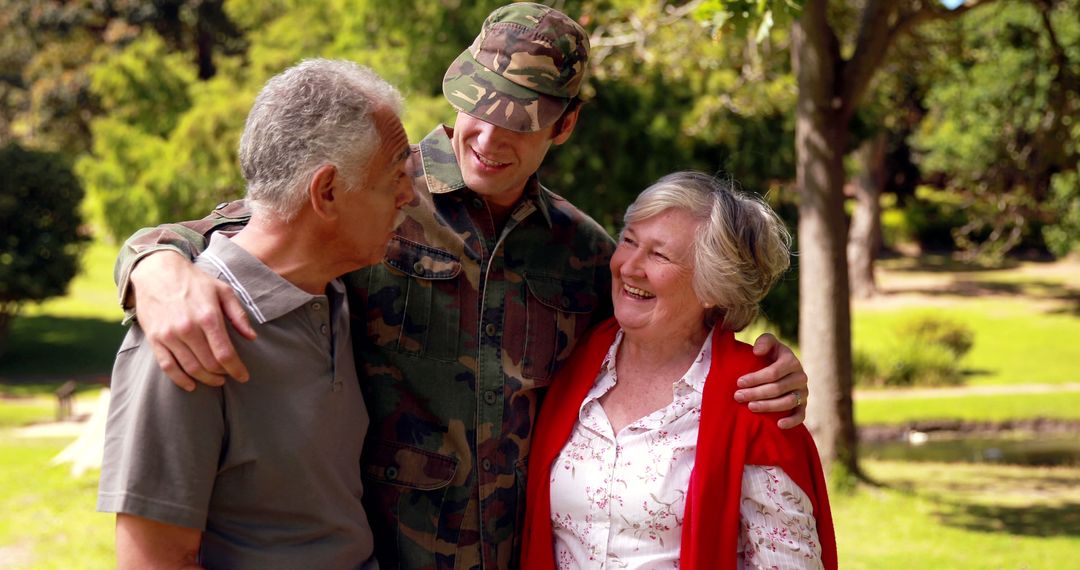 Returning Soldier Embracing Elderly Couple Outdoors
