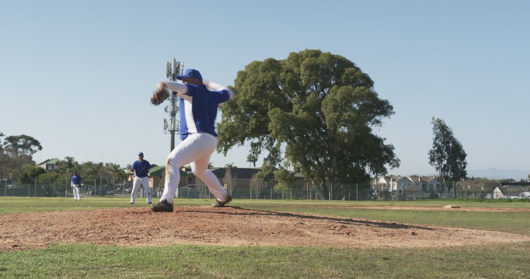 Baseball Pitcher Throwing on Sunny Day at Community Field