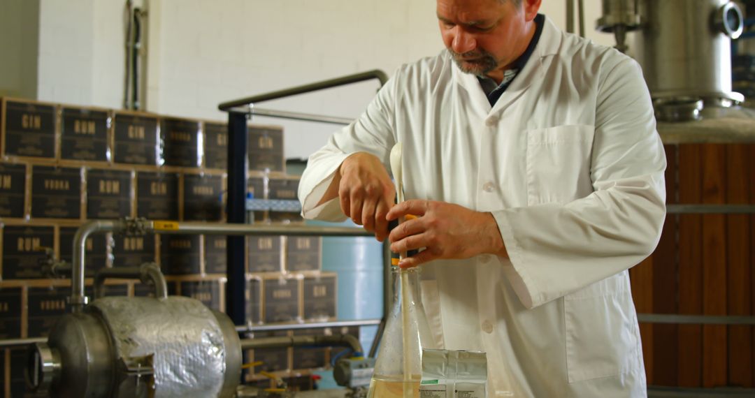 Male Chemist Conducting Experiment in Industrial Laboratory - Free Images, Stock Photos and Pictures on Pikwizard.com