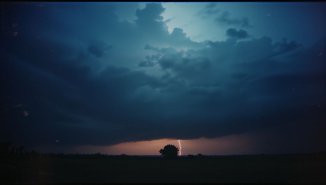 Dramatic Lightning Over Lone Tree at Dusk