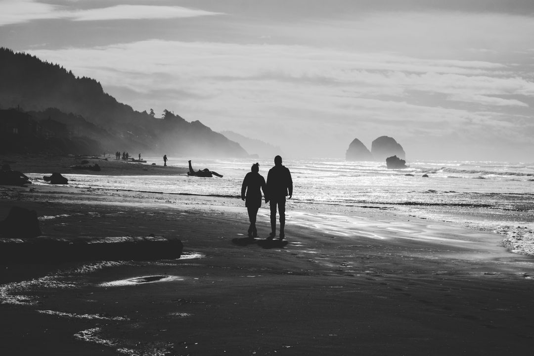 Silhouettes of Couple Walking on Scenic Beach at Sunset - Free Images, Stock Photos and Pictures on Pikwizard.com