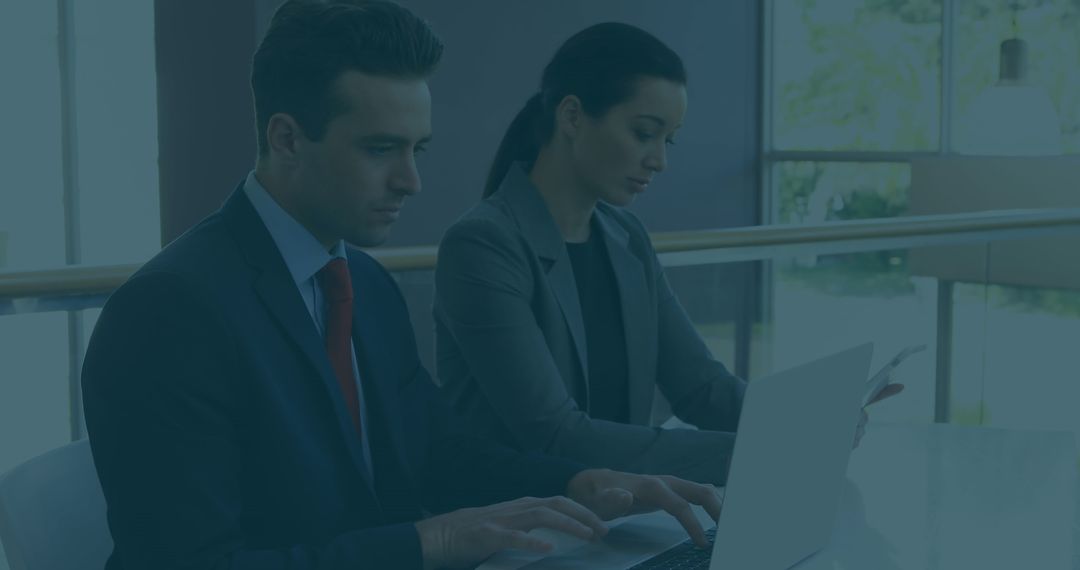 Business Professionals Analyzing Data on Laptop