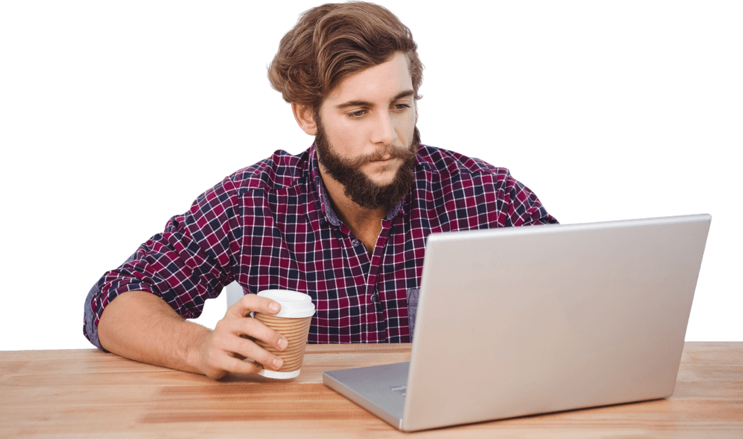 Focused Bearded Man with Coffee at Laptop on Wood Desk