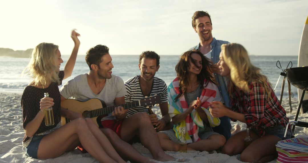 Group of Friends Enjoying Music on Beach at Sunset - Free Images, Stock Photos and Pictures on Pikwizard.com