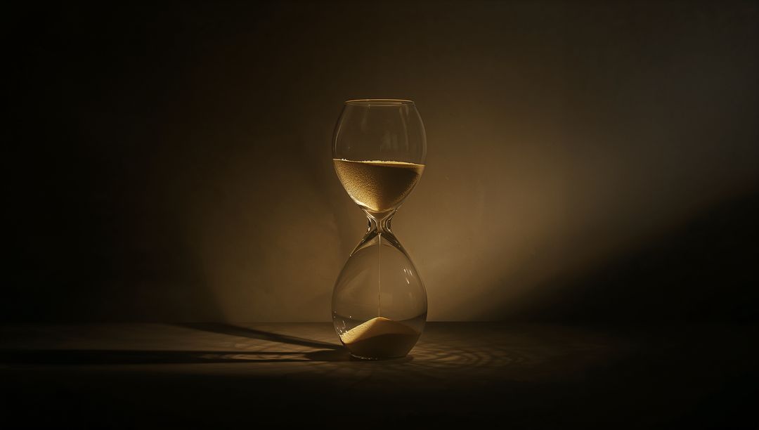 Elegant Hourglass with Golden Sand in Dim light