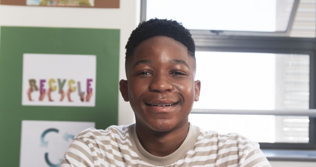 Boy Smiling In Classroom with Recycle Poster, Inspiring Learning
