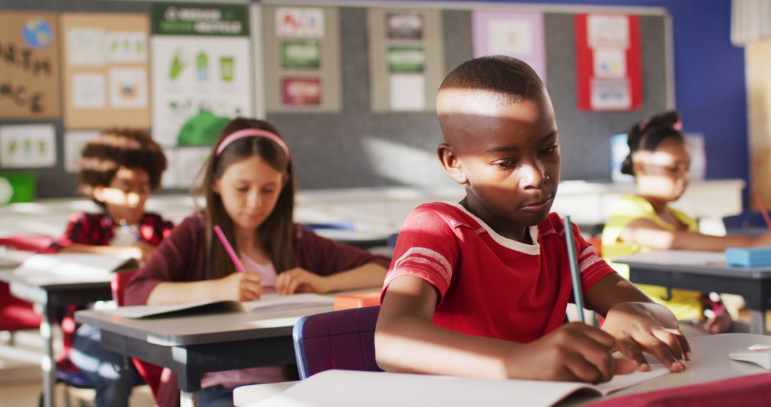 Focused Schoolchildren Taking Notes in Classroom